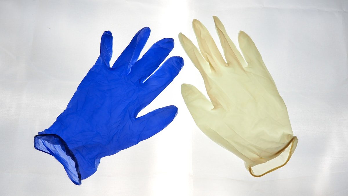 Nitrile and latex examination gloves side by side